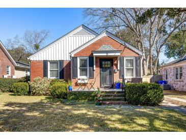 Charming brick home featuring black shutters, manicured landscaping, and a cozy front porch at 18 Sothel Ave, Charleston, SC 29407