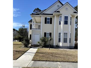 Charming two-story home boasts a welcoming front porch, classic black shutters, and a well-maintained lawn at 1861 Hubbell Dr, Mount Pleasant, SC 29466