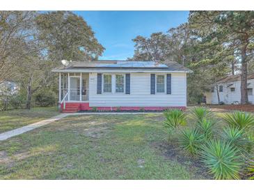 Charming exterior view of home with solar panels, blue shutters, and a screened-in front porch at 2673 Olympia Ave, North Charleston, SC 29405