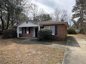 Charming single-story brick home with a well-maintained front yard and classic curb appeal at 4451 Donwood Dr, Ladson, SC 29456
