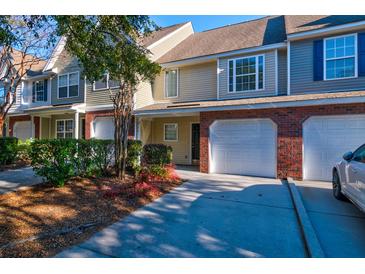Charming townhome features an attached garage, mature landscaping, and a well-maintained exterior at 546 Tayrn Dr, Charleston, SC 29492