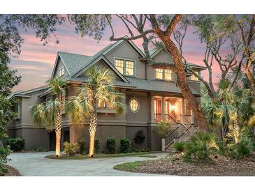 Stately home featuring lush landscaping, a circular driveway, and a welcoming entrance at 57 Goldenrod Ct, Kiawah Island, SC 29455