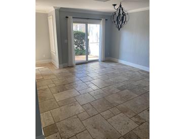 Bright dining room featuring tile floors, sliding glass doors and elegant chandelier at 604 Ventura Pl, Mount Pleasant, SC 29464