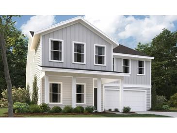 Charming two-story home with light gray siding, white trim, a covered porch, and a two-car garage at 5206 Cottage Lndg Dr, Summerville, SC 29485
