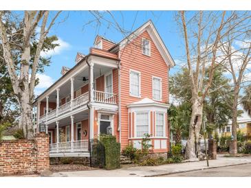 Charming two-story home with a spacious porch and bay window at 1 Percy St, Charleston, SC 29403