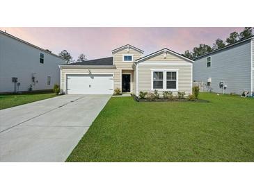Charming single-Gathering home featuring a well-manicured lawn and an attached two-car garage at 269 Firewheel Ct, Summerville, SC 29486