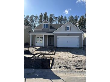 Charming single-Gathering home with a two-car garage and welcoming front porch in a residential neighborhood at 586 Marsh Cove Cir, Summerville, SC 29486