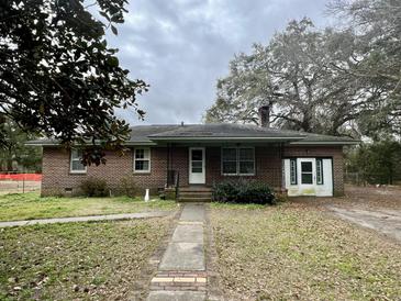 Charming brick home featuring a front porch, classic design, and inviting curb appeal at 113 Germantown Rd, Summerville, SC 29483