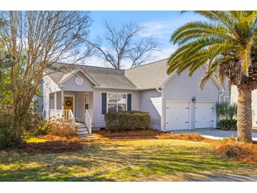 Charming single-story home with a welcoming front porch, attached two car garage and beautiful mature landscaping at 1236 Lakefront Dr, Charleston, SC 29412