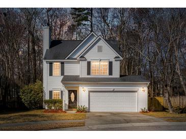 Charming two-story home features an attached two-car garage, a well-manicured lawn, and classic curb appeal at 129 E Hartwick Ln, Goose Creek, SC 29445