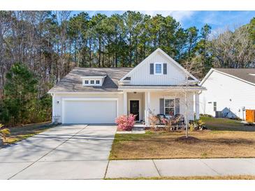 Charming one-story home with a well-manicured lawn and a welcoming front porch at 1601 Thin Pine Dr, Johns Island, SC 29455