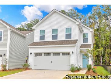 Charming two-story home featuring a two-car garage and a welcoming light blue front door at 224 Night Heron St # 629, Summerville, SC 29486