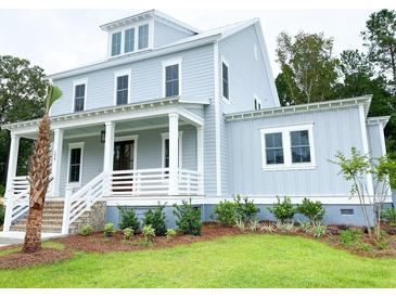 Charming two-story home with a covered front porch and a well-manicured lawn at 3897 Summerton St, Mount Pleasant, SC 29466