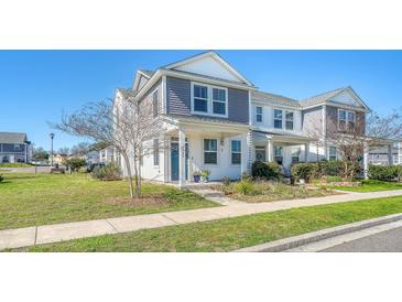 Charming two-story home with landscaped front yard and inviting covered porch at 3941 Four Poles Park Dr, North Charleston, SC 29405