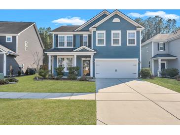 Charming two-story home featuring blue siding, white trim, a two-car garage, and a well-maintained front lawn at 429 Cherrybark Oak St, Summerville, SC 29486