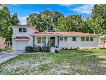 Charming brick home with a well-manicured lawn and inviting front porch and attached garage at 5332 Parkside Dr, North Charleston, SC 29405