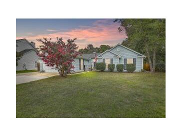 Charming single-story home with lush lawn and mature trees, perfect for suburban living at 613 Salterton St, Summerville, SC 29485