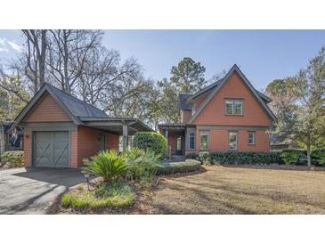 Charming home featuring a covered drive, landscaped yard, and unique architectural details at 720 Island Park Dr # 104, Charleston, SC 29492