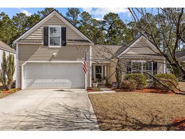 Charming home featuring a one car garage, American flag, neutral siding and well-maintained landscaping at 9021 Robins Nest Way, Summerville, SC 29485