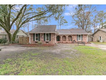 Charming brick home featuring lush yard, inviting curb appeal, and an attached two car garage at 106 Two Wood Ct, Summerville, SC 29483
