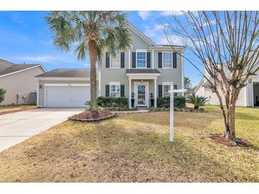 Charming two-story home with attached garage and well-manicured lawn and palm tree at 109 Walnut Creek Rd, Charleston, SC 29414