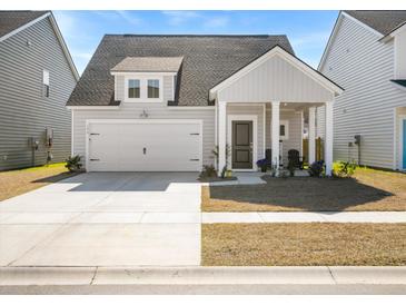 Charming home with a white garage door, inviting front porch, and a well-manicured lawn at 136 Post Mill Dr, Summerville, SC 29485