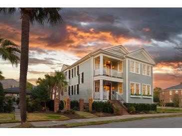 Charming two-story home with a double porch and professionally landscaped front yard with a gorgeous sunset at 146 S Battery St, Charleston, SC 29401