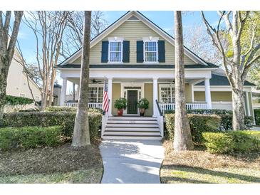 Charming home featuring a welcoming front porch, classic shutters, and manicured landscaping at 1992 Pierce St, Charleston, SC 29492