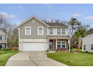 Charming two-story home with a well-manicured lawn and a two-car garage at 222 Medford Dr, Summerville, SC 29485