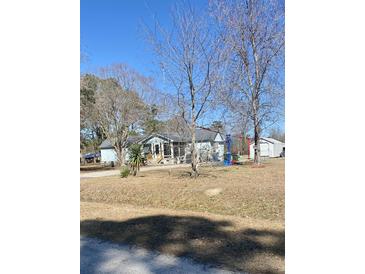 Charming single-story home with a screened-in porch and a large yard, perfect for outdoor activities at 342 Early Ln, Summerville, SC 29486