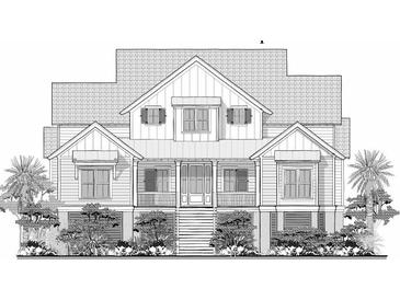 Charming two-story house with a symmetrical facade, inviting front porch, and coastal landscaping at 3902 Summerton St, Mount Pleasant, SC 29466