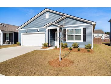 Charming one-story home featuring blue siding, a well-manicured lawn, and an attached garage on a sunny day at 400 Hampstead Ct, Summerville, SC 29486