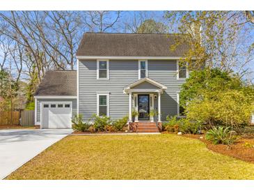 Charming two-story home featuring a well-manicured lawn and an attached two-car garage at 471 Springfield Rd, Mount Pleasant, SC 29464
