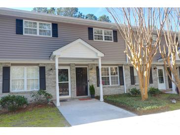 Charming townhome features a brick and siding facade, a covered entryway and a well-manicured lawn at 507 Stinson Dr # 5E, Charleston, SC 29407