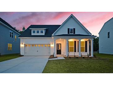 Charming single-Gathering home featuring white siding, a well-manicured lawn, and an attached two-car garage at 511 Verdi Dr, Summerville, SC 29486