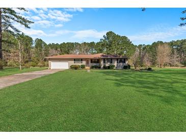 Charming single-story home with a well-maintained front yard and attached garage at 102 Wright Ln, Goose Creek, SC 29445