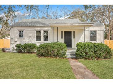 Charming single-story home with a well-manicured lawn and inviting front porch at 1744 Pinckney Park Dr, Charleston, SC 29407