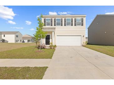 Charming two-story home with a manicured lawn and a two-car garage at 192 Lyra Ln, Summerville, SC 29486