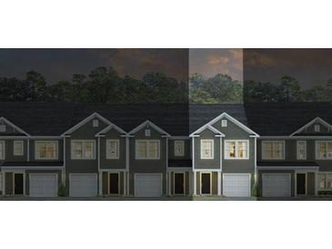 Modern townhome showcasing well-maintained exterior and individual garages, under a twilight sky at 539 Golden Embers Way, Summerville, SC 29486