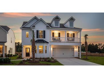 Charming two-story home with a second-story balcony and a well-manicured lawn at 587 Red Monarch Way, Moncks Corner, SC 29461