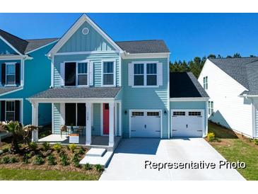 Charming two-story home with a covered front porch and an attached two-car garage at 1044 Northern Flicker Dr # Cc3-18-2P, Ravenel, SC 29470