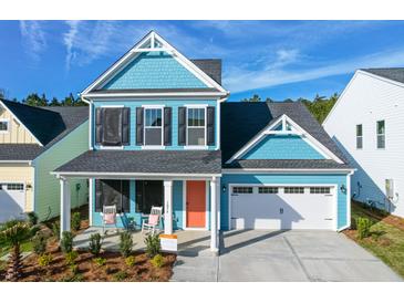Charming two-story home features a blue exterior, black shutters, and a welcoming front porch with rocking chairs at 1045 Northern Flicker Dr # Cc3-19-5P, Ravenel, SC 29470