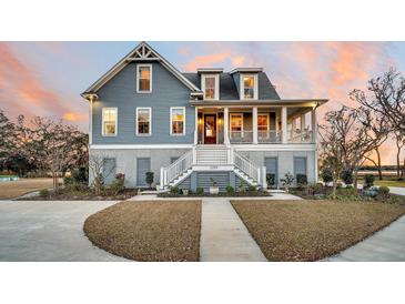 Charming two-story home featuring a spacious front porch and beautifully landscaped front yard at 1189 Pinefield Dr, Charleston, SC 29492