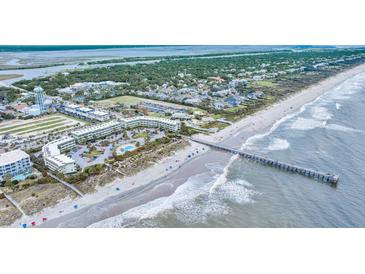 Panoramic aerial view of a beachfront resort featuring a long fishing pier and oceanfront pool at 1300 Ocean Blvd # 232, Isle of Palms, SC 29451