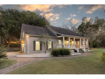 Charming home with a covered porch, landscaped yard, and brick pathway leading to the entrance at 1365 Whippoorwill Farm Rd, Johns Island, SC 29455