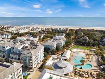 Beautiful aerial view of oceanfront resort community with pools, beach access, and well-maintained grounds at 5802 Palmetto Dr # B-202, Isle of Palms, SC 29451