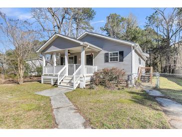 Charming single-story home with a cozy front porch and well-maintained landscaping at 2969 Bobo Rd, Mount Pleasant, SC 29466