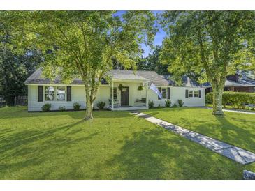Charming single-story home with a well-maintained lawn and mature trees at 318 Hollywood Dr, Charleston, SC 29407