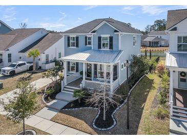 Charming two-story home with a welcoming front porch and well-manicured landscaping at 3920 Maidstone Dr, Mount Pleasant, SC 29466