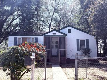 Charming single-story home with a screened-in porch, fenced yard, and mature trees at 3987 Niagara St, North Charleston, SC 29405